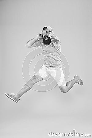 Energy of rhythm. Hipster dancing jumping headphones gadget. Inspiring song. Music library. Music fan. Man listen music Stock Photo