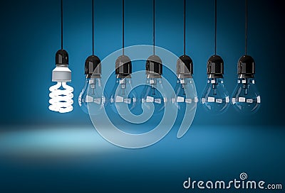 Energy saving bulb lighting incandescent bulbs on wires over blu Stock Photo