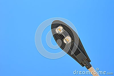 Energy saving led lamp in the street lamp against blue sky, close up Stock Photo
