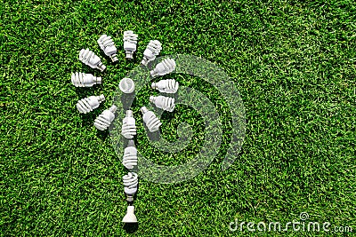 Energy saving light bulbs on green grass Stock Photo