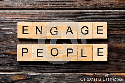 ENGAGE PEOPLE word written on wood block. ENGAGE PEOPLE text on wooden table for your desing, concept Stock Photo