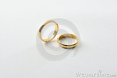 Engagement gold rings standing and lying down isolated over white Stock Photo