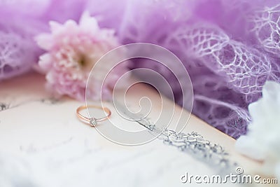 Engagement ring. Retro background with old book and chrysanthemums Stock Photo