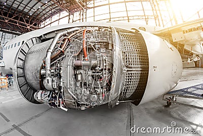 Engine of the aircraft with an open hood for repair and inspection. Stock Photo