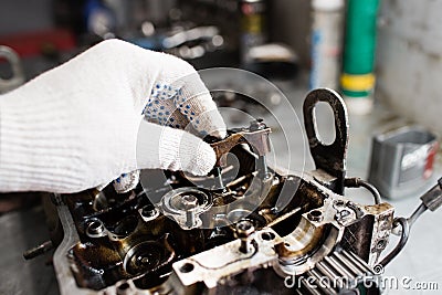 Engine crankshaft, valve cover, pistons. mechanic repairman at automobile car engine maintenance repair work Stock Photo