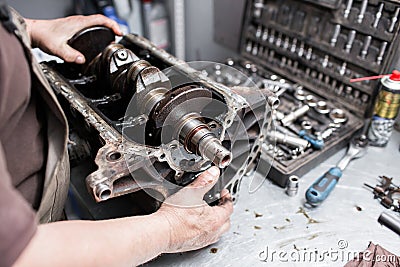 Engine crankshaft, valve cover, pistons. mechanic repairman at automobile car engine maintenance repair work Stock Photo