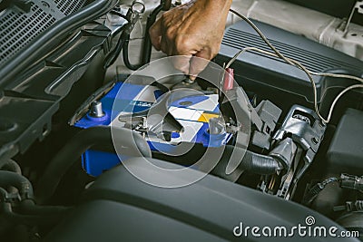 Engine engineer is replacing car battery because car battery is depleted. concept car maintenance And the cost of car care. Stock Photo