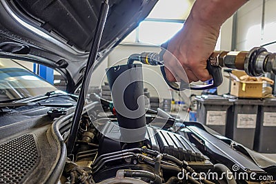 Engine oil is filled into a car engine Stock Photo