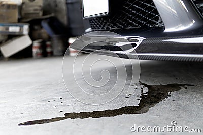 Engine oil stains a car Leak under the car when the car is park on the road service photo concept for check and maintenance Stock Photo