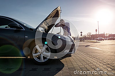 Engine problem. Driver man near open hood vehicle broken down on road. Auto motor car problem concept. Stock Photo