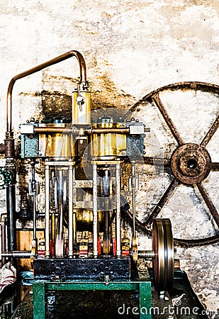 Engine and a set of wheels resting side by side on a flat surface Stock Photo