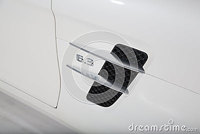 Engine size logo on the side of a white Mercedes AMG car Editorial Stock Photo