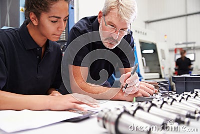 Engineer And Apprentice Planning CNC Machinery Project Stock Photo