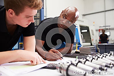 Engineer And Apprentice Planning CNC Machinery Project Stock Photo