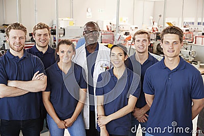 Engineer with apprentices in factory, group portrait Stock Photo