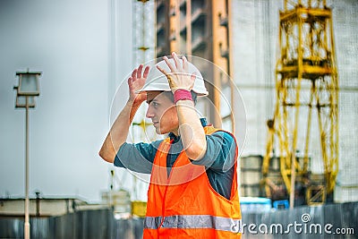 Engineer or Architect checking personal protective equipment safety helmet at construction site Stock Photo