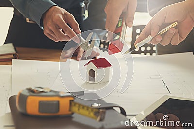 Engineer and Architect concept, Engineer Architects office team working and discussing with blueprints and house model Stock Photo