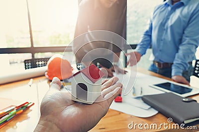 Engineer and Architect concept, Engineer Architects office team working and discussing with blueprints and house model, Stock Photo