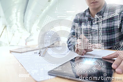 Engineer or Architect looking and touching interface with building design reality virtual technology on computer tablet at modern Stock Photo