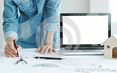 Engineer architects discussing on the table with blueprint with blank screen laptop Stock Photo