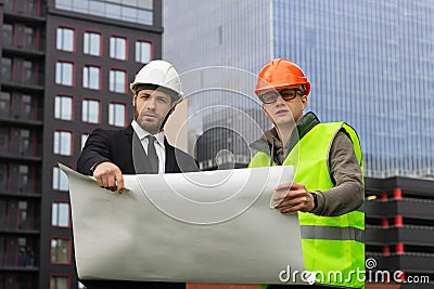 Engineer and builder explaining drawing architect plan professional Stock Photo