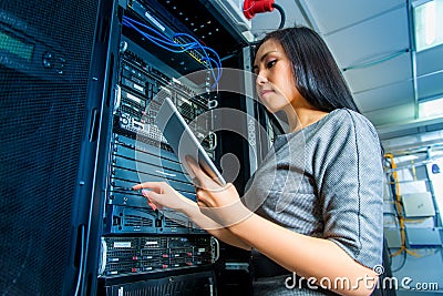 Engineer businesswoman in network server room Stock Photo