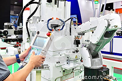 Engineer check and control automation white Modern Robot Arm system in factory Stock Photo