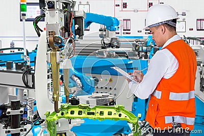 Engineer check maintenance daily of automated automotive robot Stock Photo