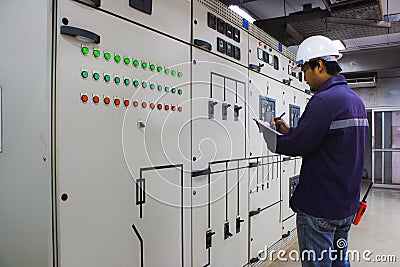 Engineer checking the electrical system in the control room Stock Photo