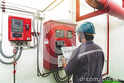 Engineer checking industrial generator fire control system Editorial Stock Photo