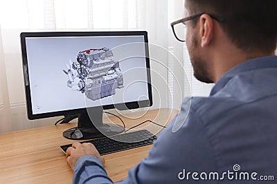 Engineer, Constructor, Designer in Glasses Working on a Personal Computer. He is Creating, Designing a New 3D Model of Car Engine Editorial Stock Photo