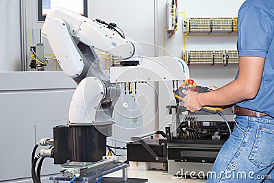 Engineer controlling automated robotic for holding assembly Stock Photo