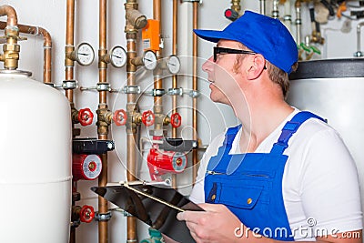 Engineer controlling the heating system Stock Photo