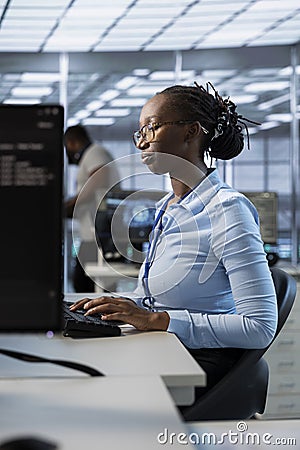 Engineer in data center managing and optimizing large scale IT infrastructure Stock Photo