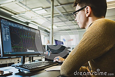 Engineer designer working on desktop computer in factory Stock Photo
