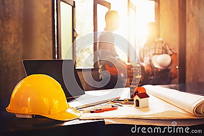 Engineer desk with object and paper with blurry engineer teamwork hardworking to consults about their small business building pro Stock Photo