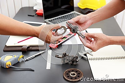 Engineer discussing and designing about mechanical gear parts in office Stock Photo