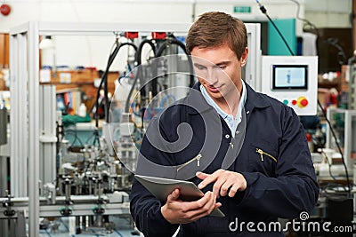 Engineer In Factory Using Digital Tablet Stock Photo