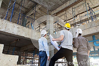 Engineer, foreman and worker discussing in construction site Editorial Stock Photo