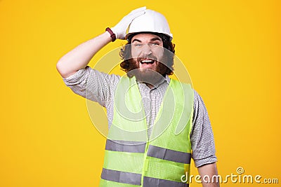 Engineer forgot something to do, face expression of constructor wearing helmet Stock Photo
