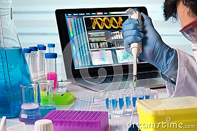 Engineer genetic working in laboratory with pipette Stock Photo