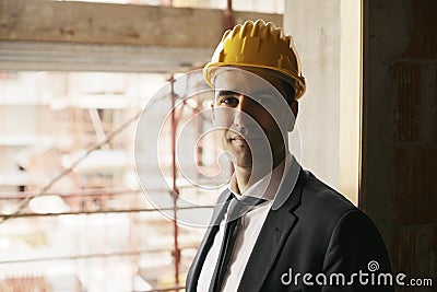 Engineer with helmet in construction site smiling at camera, portrait Stock Photo