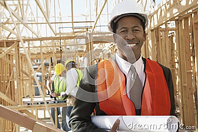 Engineer Holding Blueprint At Construction Site Stock Photo