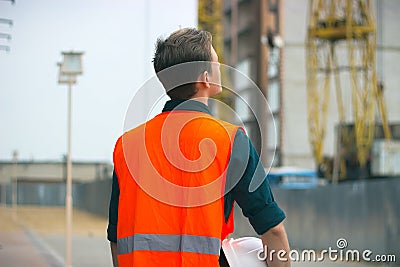 The engineer holding the white helmet safety at construction site with crane Editorial Stock Photo