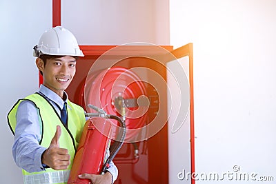 Engineer inspection Fire extinguisher and fire hose. Stock Photo