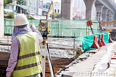 Engineer instructing while operating dumpy automatic level instr Editorial Stock Photo