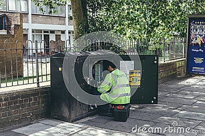 Engineer maintenance telecommunication stand on a street Editorial Stock Photo