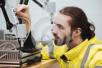 Engineer male education in Industrial Robotics program in university engineering lab classroom learning assembly robot mechanical Stock Photo