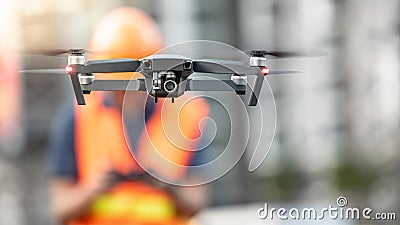 Engineer man flying drone over construction site Stock Photo