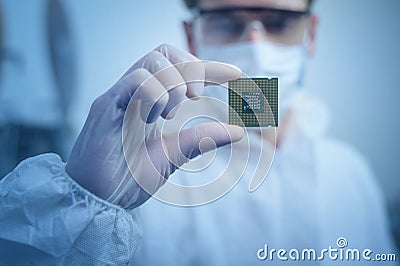 Engineer man in sterile suit is holding Microchip with symbols in modern design factory , futuristic and artificial intelligence Stock Photo
